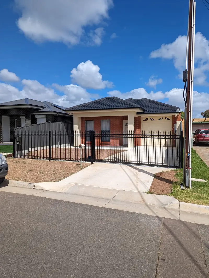 Black tubular steel front fence and sliding gate on a new home