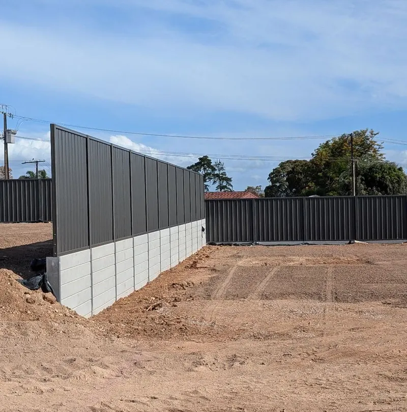 Concrete sleeper retaining wall with fence on a new block