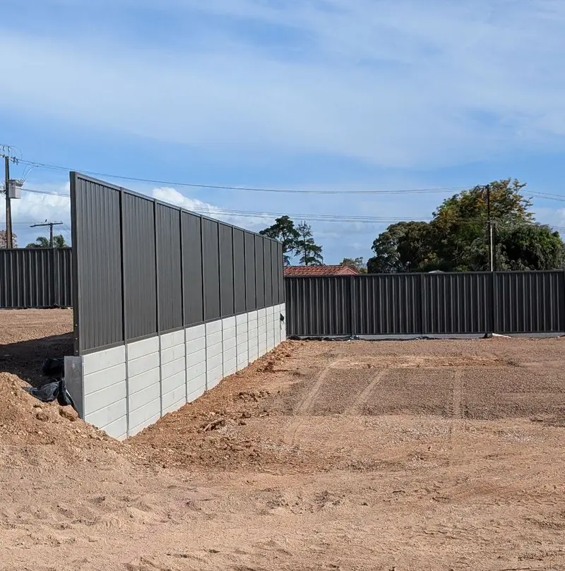 Concrete sleeper retaining wall with fence on a new block