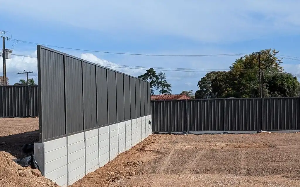 Colorbond fence on a concrete sleeper retaining wall